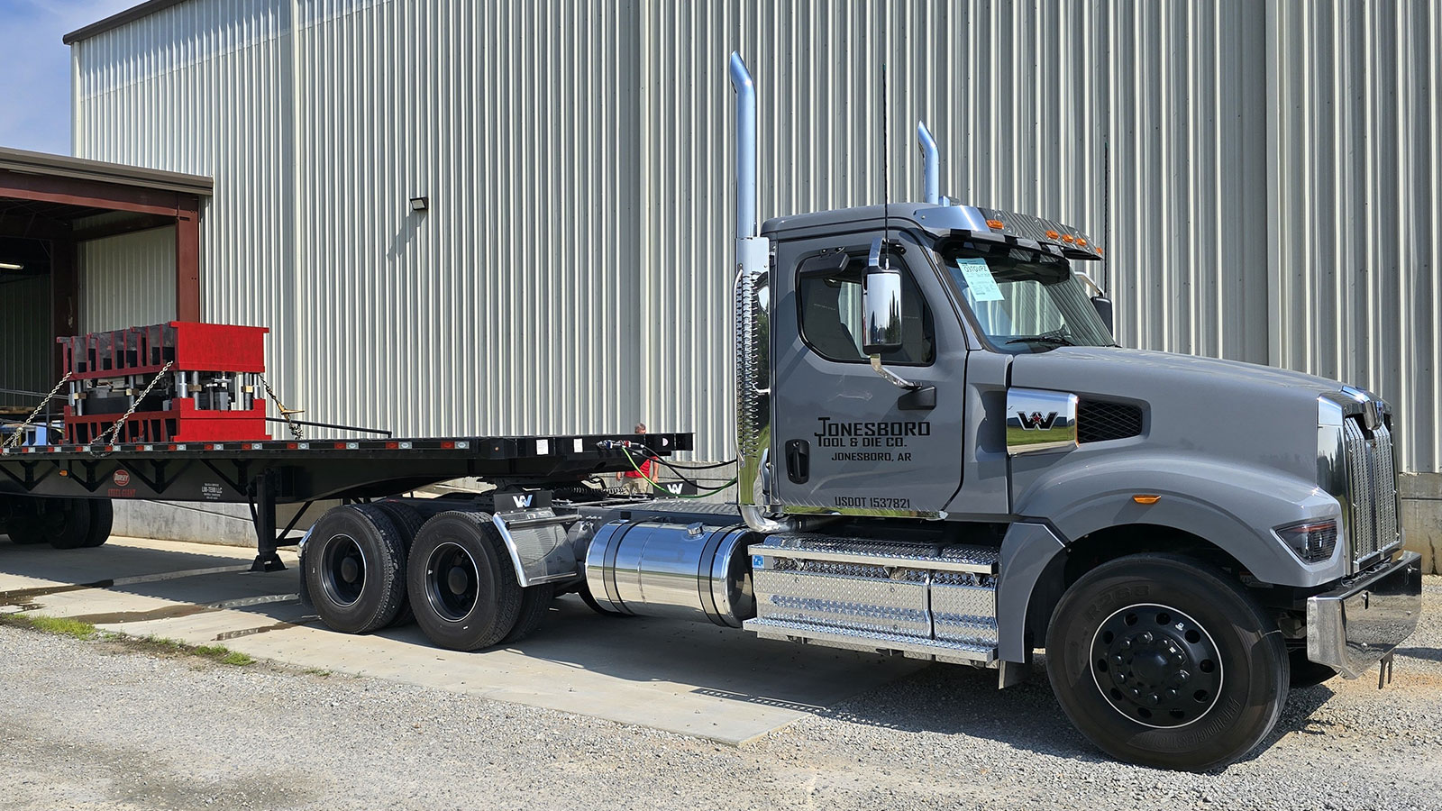 A JTD truck and trailer being prepped and loaded with a die cast.
