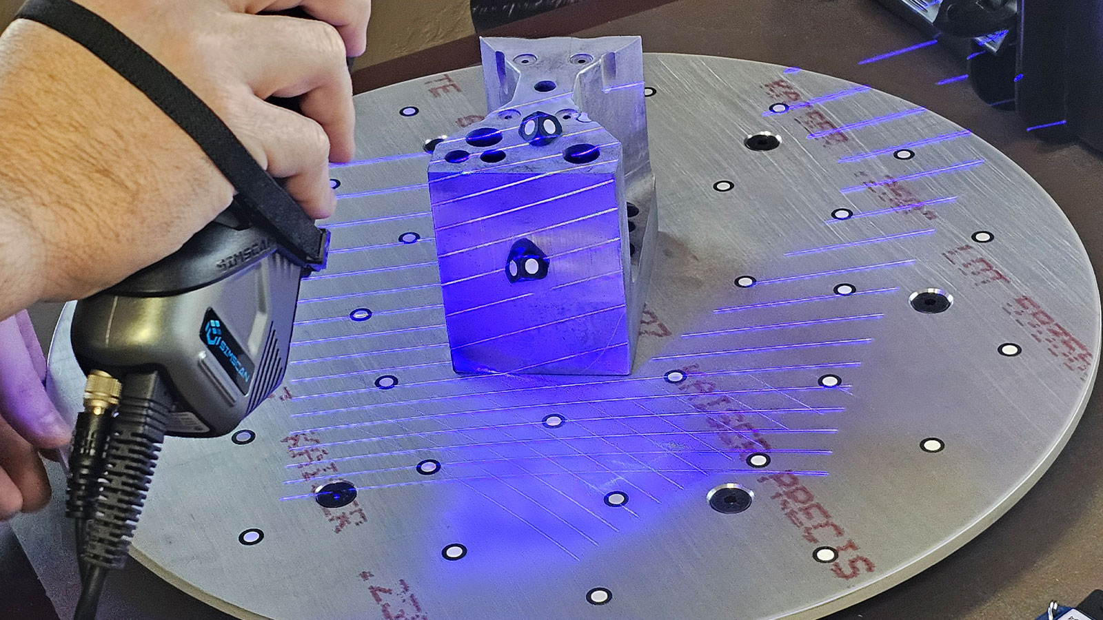 A Scanology handheld 3d scanner, the Simscan-E Gen 2 scanning a part.