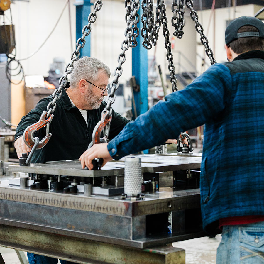 Two JTD Craftsmen building a die.