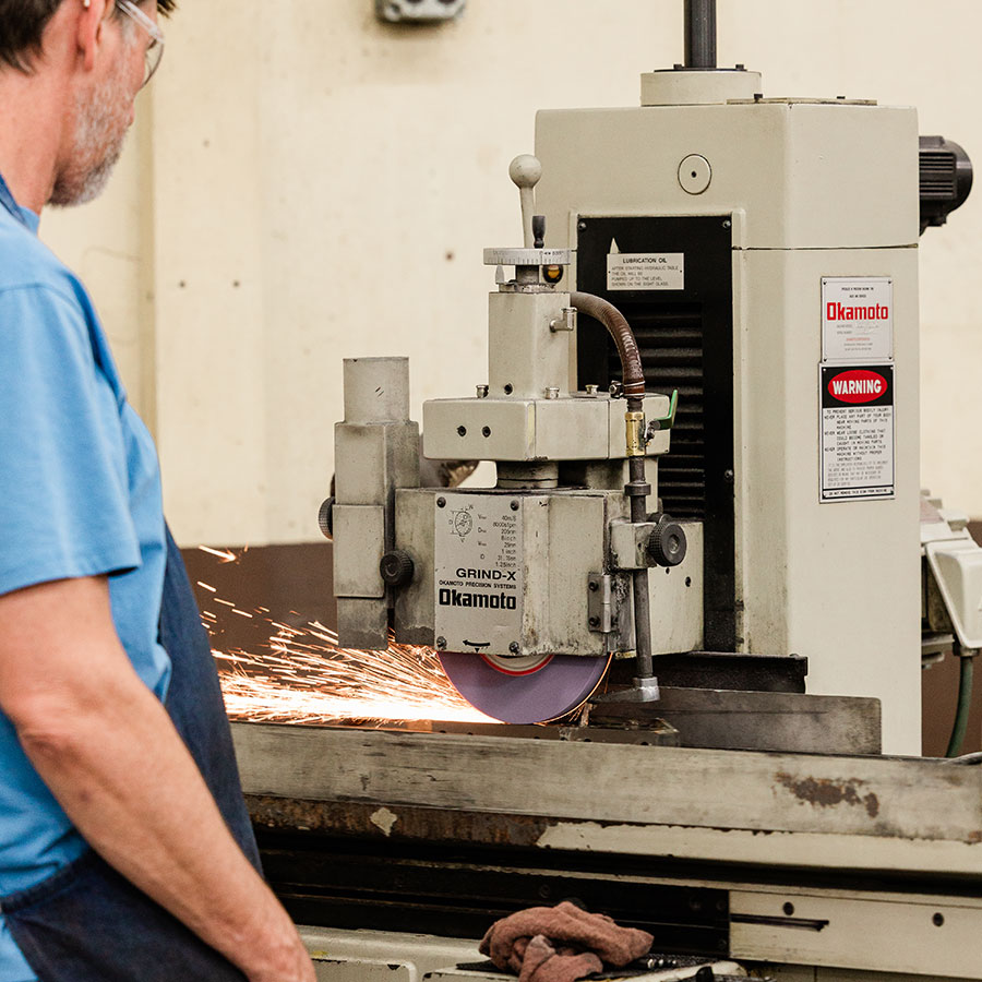 Jonesboro Tool and Die craftsman using a surface grinder.
