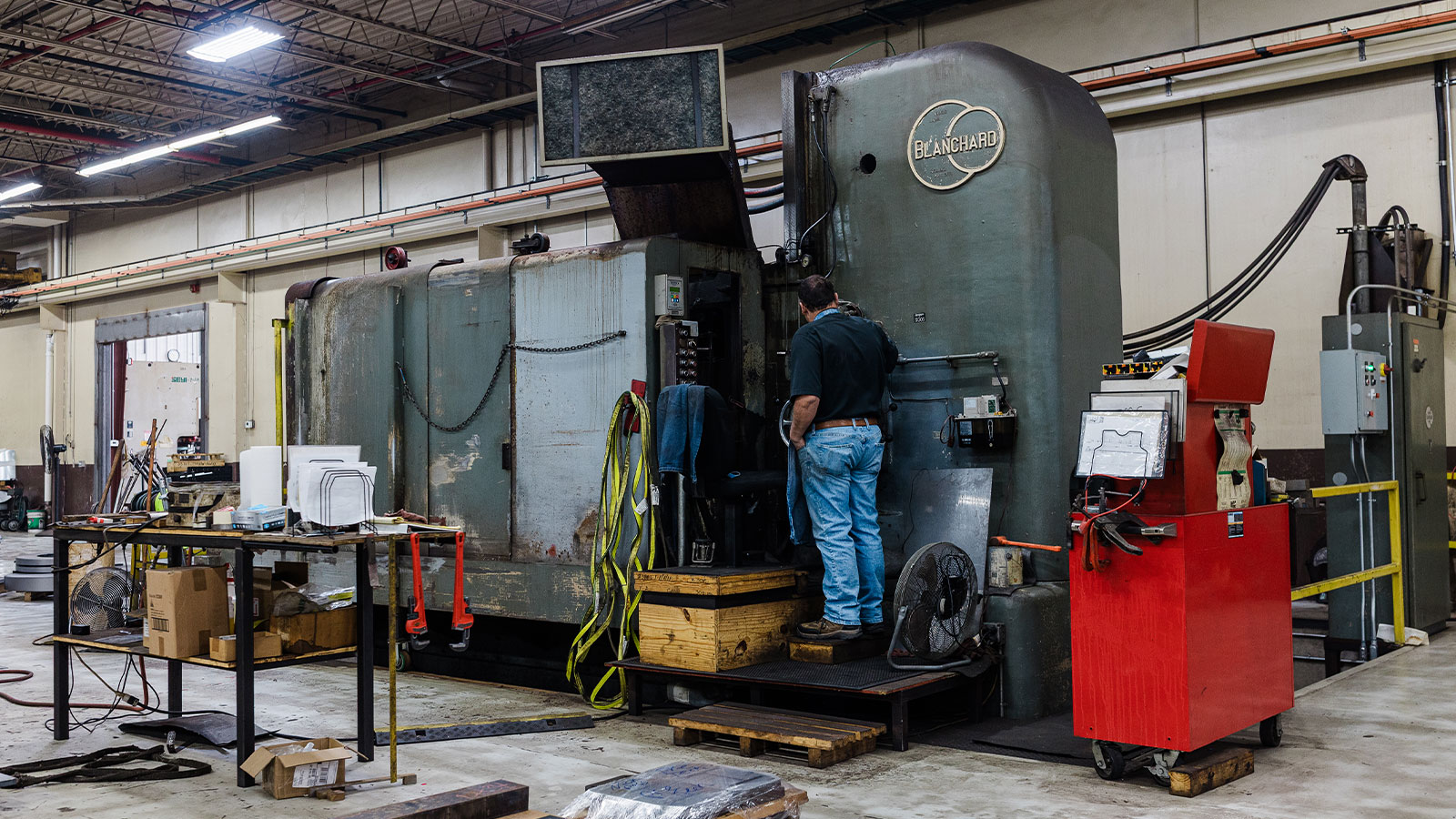 Blanchard vertical rotary surface grinder being used at JTD by an employee.