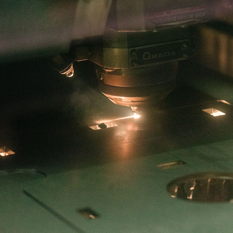 Fiber Amada Precision Laser cutting a design.